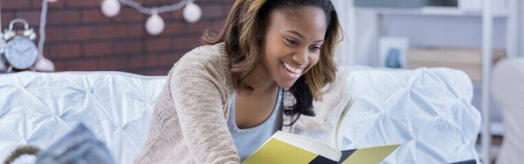 A student smiling whilst studying